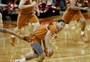Texas' Cory Joseph is held back by Nebraska's Eshaunte Jones, left, during the second half of an NCAA college basketball game, in Lincoln, Neb., Saturday, Feb. 19, 2011. Nebraska beat Texas 70-67.