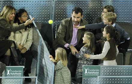 Spain's Crown Prince Felipe, Center, Eyes A Tennis Ball Thrown By An Unidentified Person, Left, To His Daughters,