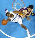 New Orleans Hornets forward Trevor Ariza (1) leaps near the basket against Los Angeles Lakers forward Pau Gasol , (16), of Spain, during the first half of game four of a first-round NBA basketball playoff series in New Orleans, Sunday, April 24, 2011. The Hornets won 93-88 to tie the series at two apiece.