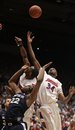 Xavier's Jamel McLean (22) and Dayton's Chris Wright, center, and Devin Searcy (34) battle for a rebound during the second half of an NCAA college basketball game on Sunday, Feb. 27, 2011, in Dayton, Ohio . Xavier defeated Dayton 66-62.