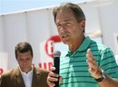 Alabama football coach Nick Saban, right, speaks as Tuscaloosa Mayor Walt Maddox, left, looks on, at the site of a home in the Holt community in Tuscaloosa, Ala., Friday, May 20, 2011. Nick and Terry Saban donated $50,000 to a group to help rebuild the home of Teddy and Rosie Rowe who lost their home in the April 27 tornado.