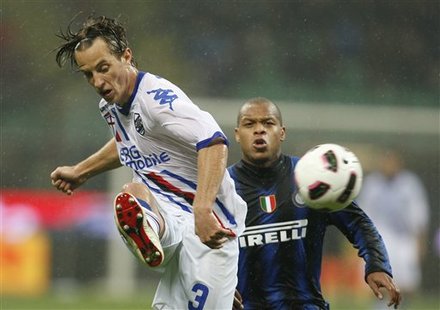 Sampdoria Defender Reto Ziegler, Left, Of Switzerland, Challenges For The Ball With Inter Milan Forward Jonathan