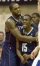 Connecticut's Alex Oriakhi gives Kemba Walker (15) a hug after Walker was fouled by Kentucky guard DeAndre Liggins in the first half of an NCAA college basketball game at the Maui Invitational in Lahaina, Hawaii, Wednesday, Nov. 24, 2010.