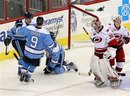 Pittsburgh Penguins ' Sidney Crosby , left, Pascal Dupuis (9) and Alex Goligoski (3) react follwoing Dupuis' goal against Carolina Hurricanes goalie Cam Ward (30) during the third period of an NHL hockey game in Raleigh, N.C., Saturday, Oct. 30, 2010. Pittsbugh won 3-0. Hurricanes' Jeff Skinner , right, reacts.