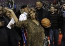 Aretha Franklin walks on the court with Jesse Jackson after the Detroit Pistons - Miami Heat NBA basketball game in Auburn Hills, Mich., Friday, Feb. 11, 2011.