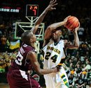 Baylor's LaceDarius Dunn, right, is defended by Texas A&M Naji Hibbert, left, in the second half of a NCAA basketball game, Saturday, Feb 26, 2011, in Waco, Texas. Baylor won 58-51.