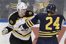Boston Bruins ' Zdeno Chara (33), of Slovakia, and Buffalo Sabres ' Robyn Regehr (24) fight during the first period of an NHL hockey game, Wednesday, Nov. 23, 2011, in Buffalo, N.Y. The Bruins won 4-3 in a shootout.