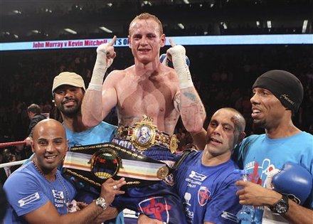 Britain's George Groves, Center, Celebrates With His Team, Including World Super-heavyweight Champion, David Haye,
