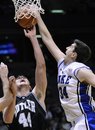 Duke' Ryan Kelly, right, blocks a shot by Butler's Andrew Smith during the first half of an NCAA college basketball game Saturday, Dec. 4, 2010 in East Rutherford, N.J.