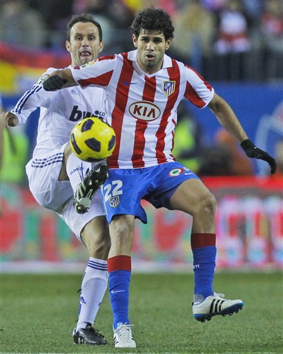 Real Madrid's Ricardo Carvalho From Portugal, Left, Vies For The Ball Against Atletico De Madrid's Diego Costa From