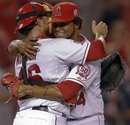 Los Angeles Angels starting pitcher Ervin Santana , right, hugs catcher Bobby Wilson after their win against the Minnesota Twins during a baseball game in Anaheim, Calif., Tuesday, Aug. 2, 2011. Santana pitched a complete game.