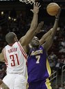 Los Angeles Lakers ' Lamar Odom (7) goes to the basket while guarded by Houston Rockets ' Shane Battier (31) during the first half of an NBA basketball game Wednesday, Dec. 1, 2010, in Houston.
