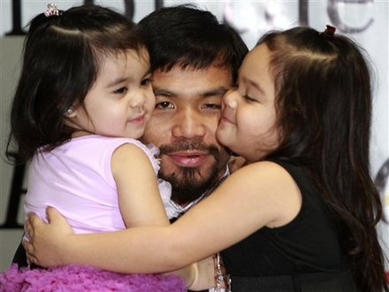 Filipino boxing champion Manny Pacquiao hugs his daughters Queen Elizabeth, left, and Princess upon arrival early Saturday Nov. 20, 2010 at the Manila International Airport in Manila, Philippines, from Los Angeles. Pacquiao, now a congressman, defeated Mexico's Antonio Margarito in their WBC super welterweight fight on Nov. 13 to become the only boxer to hold 8 championship belts in 8 different divisions.
