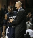 Xavier head coach Chris Mack talks with guard Tu Holloway (52) in the overtime period of an NCAA college basketball game against Vanderbilt on Monday, Nov. 28, 2011, in Nashville, Tenn. Holloway led Xavier with 24 points as they won in overtime 82-70.