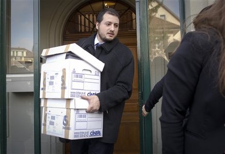 A member of the Spanish cyclist federation carries boxes with papers after leaving the world sport's highest court