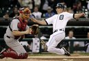 Detroit Tigers ' Andy Dirks , right, scores against Boston Red Sox catcher Jason Varitek from first base on a double by Brennan Boesch in the first inning of game two of a baseball double-header Sunday, May 29, 2011 in Detroit.