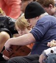 Actor Philip Seymour Hoffman interacts with his son, Cooper, as the New York Knicks play the Chicago Bulls in an NBA basketball game at Madison Square Garden  in New York, Saturday, Dec. 25, 2010.