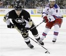 Pittsburgh Penguins ' Chris Kunitz (14) brings the puck up the ice ahead of New York Rangers ' Brandon Prust (8) in the second period of the NHL hockey game, Sunday, March 20, 2011 in Pittsburgh. The Rangers won 5-2.