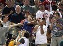 Fans catch a fly ball off the bat of Atlanta Braves ' Jordan Schafer , not pictured, in the sixth inning of a baseball game against the Cincinnati Reds Sunday, May 29, 2011 in Atlanta. Atlanta won 2-1.