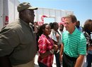 Alabama football coach Nick Saban, right, speaks with Teddy Rowe, left, and daughter, Helen Sims, at the site of a home in the Holt community of Tuscaloosa, Ala. Friday, May 20, 2011. Nick and Terry Saban donated $50,000 to a group to help rebuild the home of Teddy and Rosie Rowe who lost their home in the April 27 tornado.