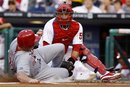 Cincinnati Reds ' Jay Bruce , left, is tagged out at home plate by Philadelphia Phillies catcher Carlos Ruiz after trying to score on a fielder's choice by Edgar Renteria in the second inning of a baseball game on Wednesday, May 25, 2011, in Philadelphia. Renteria was safe at first.