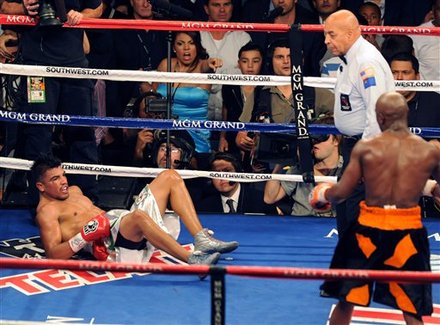 In This Photo Provided By The Las Vegas News Bureau, Floyd Mayweather Knocks Out Victor Ortiz As Referee Joe Cortez