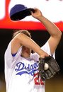 Los Angeles Dodgers starting pitcher Clayton Kershaw wipes his head after walking in a run during the fourth inning of a baseball game against the San Francisco Giants , Wednesday, May 18, 2011, in Los Angeles.