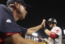 Boston Red Sox manager Terry Francona, left, gives a high-five to Ryan Lavarnway after he scored on a double by Marco Scutaro in the eighth inning of a baseball game against the Texas Rangers in Arlington, Texas, Tuesday, Aug. 23, 2011. The Red Sox won 11-5.