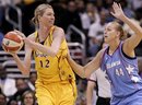 FILE - This Sept. 11, 2008, file photo shows Los Angeles Sparks ' Margo Dydek, left, protects the ball as Atlanta Dream 's Katie Feenstra, right, defends during Dream's 83-72 victory in a WNBA basketball game, in Los Angeles.  Dydek has suffered a heart attack and is in a medically induced coma in a Brisbane, Australia hospital. Basketball Australia said Friday, May 20, 2011,  that the 37-year-old Poland-born Dydek suffered the heart attack on Thursday.