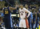 Toronto Raptors forward Leandro Barbosa , center, looks on as Denver Nuggets teammates Nene, (31) and J.R. Smith , right, celebrate their win during an NBA basketball game in Toronto, Friday, Dec. 10, 2010.