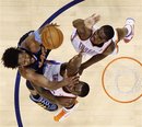 Denver Nuggets center Nene, left, of Brazil, shoots over Oklahoma City Thunder center Kendrick Perkins , center, and forward Serge Ibaka , right, of Republic of Congo, in the third quarter of Game 5 of a first-round NBA basketball playoff series in Oklahoma City, Thursday, April 28, 2011. Oklahoma City won 100-97.