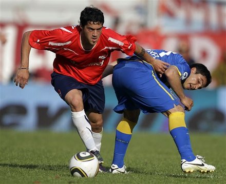 Boca Juniors' Cristian Chavez, Right, Fights
