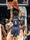 Minnesota Timberwolves  forward Michael Beasley (8) shoots over New York Knicks forwards Wilson Chandler (21) and Amare Stoudemire (1) during the first half of an NBA basketball game Monday, Dec. 6, 2010, in New York.