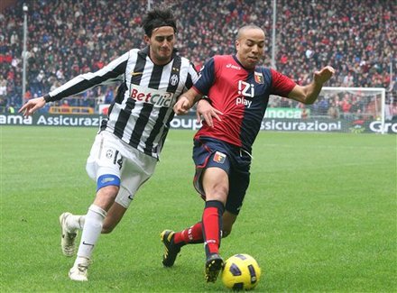 Juventus' Alberto Aquilani, Left, And Genoa's Houssine Kharja, Of Morocco, Fight For The Ball