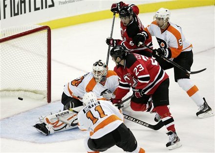 New Jersey Devils' David Clarkson (23) Shots The Puck Past Philadelphia Flyers Goalie Ilya Bryzgalov (30), Of Russia,