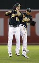 Oakland Athletics ' Josh Willingham (16) and Coco Crisp (4) celebrate a 6-1 win over the Detroit Tigers during a baseball game in Oakland, Calif.,  Thursday, Sept. 15, 2011.