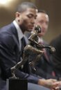 Chicago Bulls ' Derrick Rose sits next to the Maurice Podoloff Trophy before being named NBA basketball's MVP, Tuesday, May 3, 2011, in Lincolnshire, Ill. Rose is the second Bull to win the award, and the youngest recipent in league history.