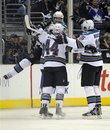 San Jose Sharks team members celebrate a goal by defenseman Jason Demers during the second period in Game 4 of a first-round NHL Stanley Cup playoffs hockey series against the Los Angeles Kings , Thursday, April 21, 2011, in Los Angeles.