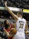 Houston Rockets forward Luis Scola , left, of Argentina, puts up a shot against Indiana Pacers forward Josh McRoberts (32) during the first quarter of an NBA basketball game in Indianapolis, Friday, Nov. 12, 2010.