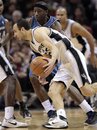 San Antonio Spurs ' Manu Ginobili , of Argentina, works the ball around Washington Wizards ' Josh Howard during the fourth quarter of an NBA basketball game, Sunday, Dec. 26, 2010, in San Antonio. San Antonio won 94-80.