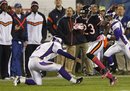 Chicago Bears wide receiver Devin Hester (23) avoids a tackle by Minnesota Vikings kicker Ryan Longwell on his way to a 98-yard kickoff return in the second half of an NFL football game, Sunday, Oct. 16, 2011, in Chicago.