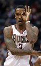 Milwaukee Bucks ' Brandon Jennings signals his 3-point basket against the Cleveland Cavaliers in the first half of an NBA basketball game Saturday, April, 9, 2011, in Milwaukee.