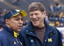 Former Michigan running back Mike Hart, left, and former quarterback Rick Leach share a laugh before Michigan's spring NCAA college football game at Michigan Stadium, Saturday, April 16, 2011, in Ann Arbor, Mich. Leach and Hart have voiced support for new coach Brady Hoke's hire.