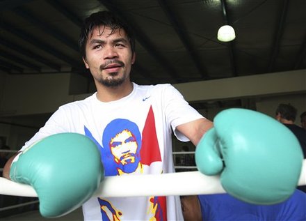 FILE - This Sept. 20, 2010, file photo shows Filipino boxing champion Manny Pacquiao taking a break in a training session at the Elorde Gym in Manila, Philippines.  The pound-for-pound king has been preparing for his upcoming fight Nov. 20 against Antonio Margarito in his native Philippines, where Typhoon Megi recently struck.