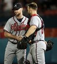 Atlanta Braves relief pitcher Jonny Venters , left, and catcher David Ross (8) celebrate after the baseball game against the Florida Marlins in Miami, Wednesday, Aug. 10, 2011. The Braves won 6-2.