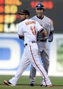 New York Yankees ' Derek Jeter , right, reacts after he was caught in a rundown by Baltimore Orioles second baseman Robert Andino (11) on a ground-out by Yankees' Curtis Granderson during the first inning of a baseball game on Wednesday, May 18, 2011, in Baltimore.