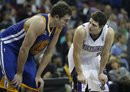 Sacramento Kings guard Jimmer Fredette , right, and Golden State Warriors center David Lee talk at the free throw line during the second half of an NBA preseason basketball game in Sacramento, Calif., Tuesday, Dec., 20, 2011. The Kings won 95-91.