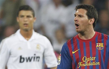 FC Barcelona's Lionel Messi From Argentina, Right, Gestures Besides Real Madrid's Cristiano Ronaldo From Portugal, Left