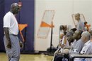 Charlotte Bobcats owner Michael Jordan, left, talks to Rod Higgins, second from right, head coach Paul Silas, third from right, and Rich Sheubrooks, right,  during a pre-draft workout for the NBA basketball team in Charlotte, N.C., Monday, June 20, 2011.