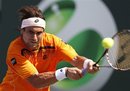 David Ferrer , of Spain, returns a shot to Mardy Fish at the Sony Ericsson Open tennis tournament in Key Biscayne, Fla., Wednesday, March 30, 2011.